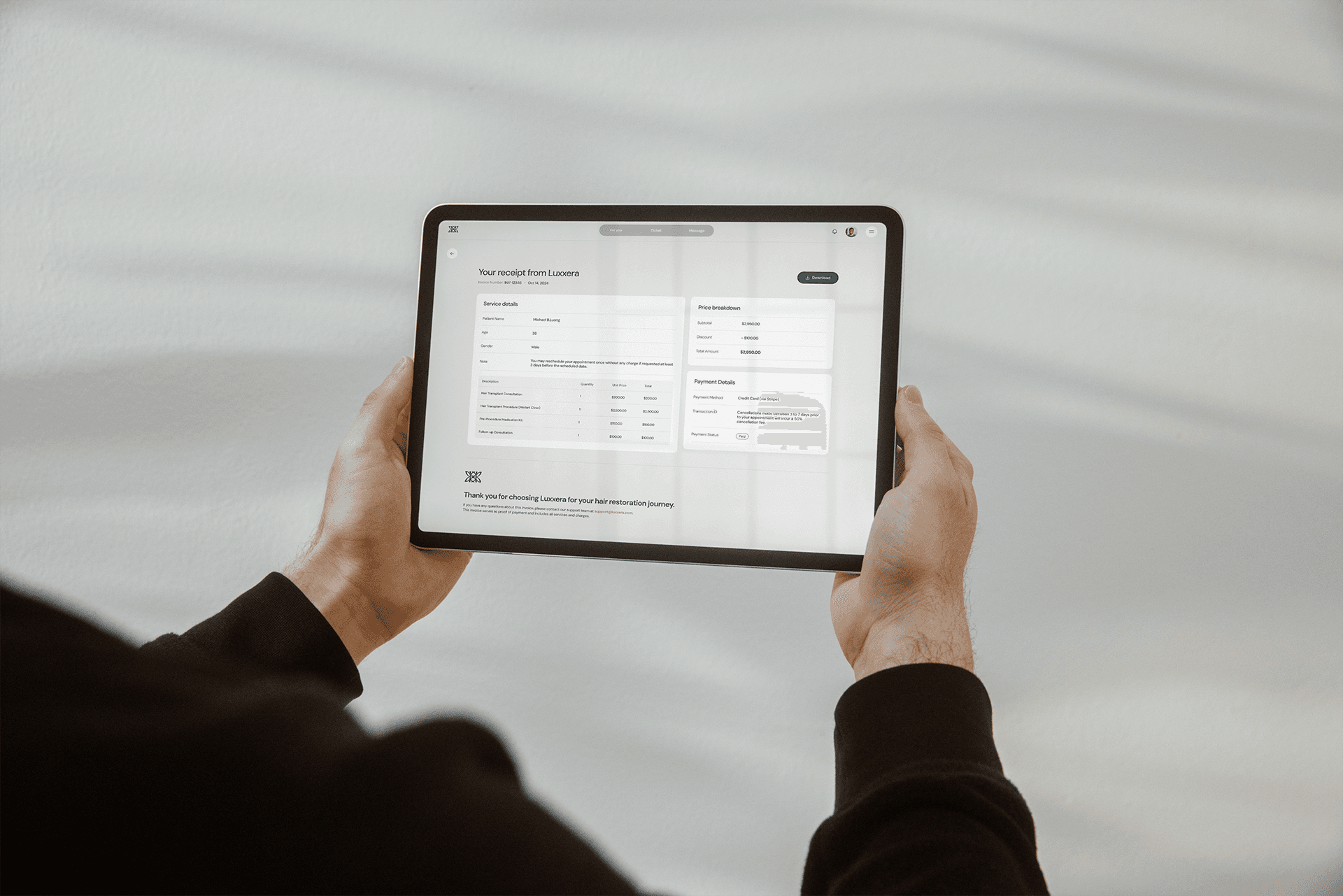 Person holding a tablet looking at Luxxera