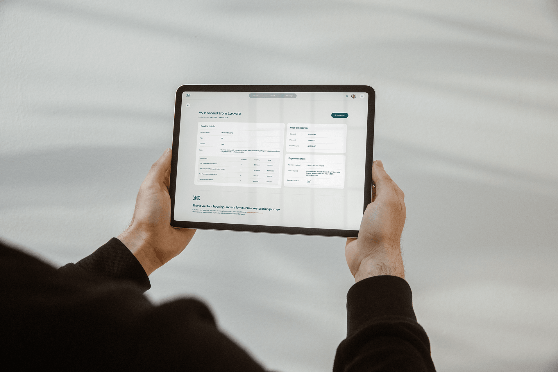 Person holding a tablet looking at Luxxera