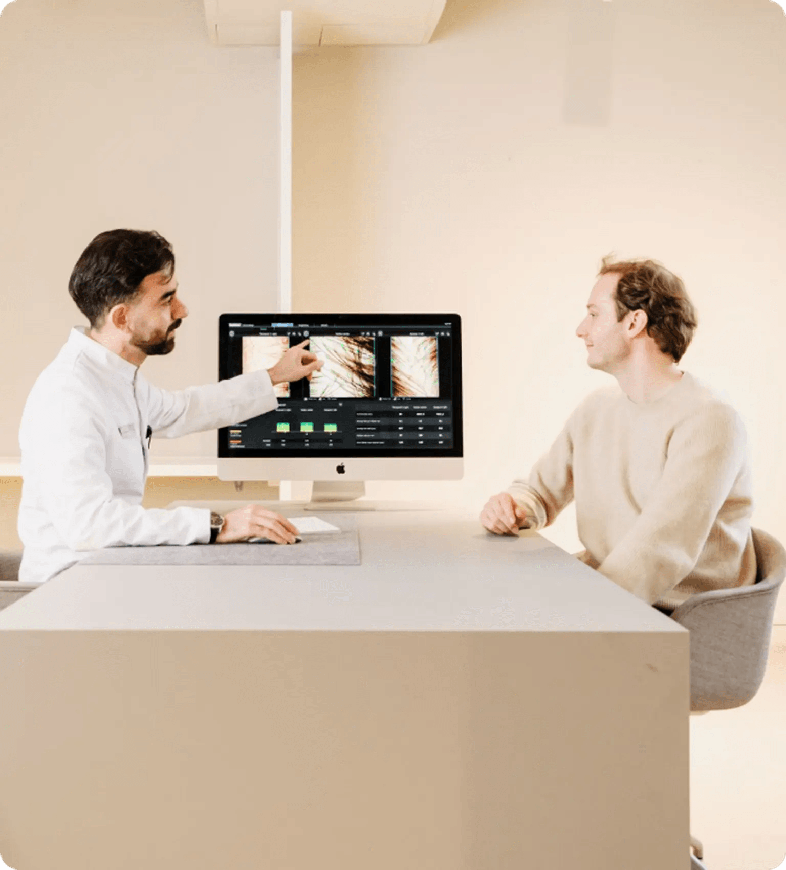 Doctor pointing to results on a screen